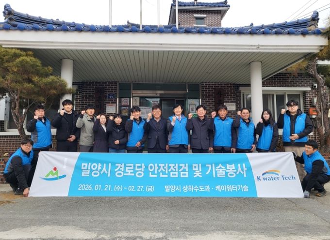 단장면 사촌마을 경로당에서 밀양시와 케이워터기술 관계자들이 기술봉사를 앞두고 기념촬영을 하고 있다.